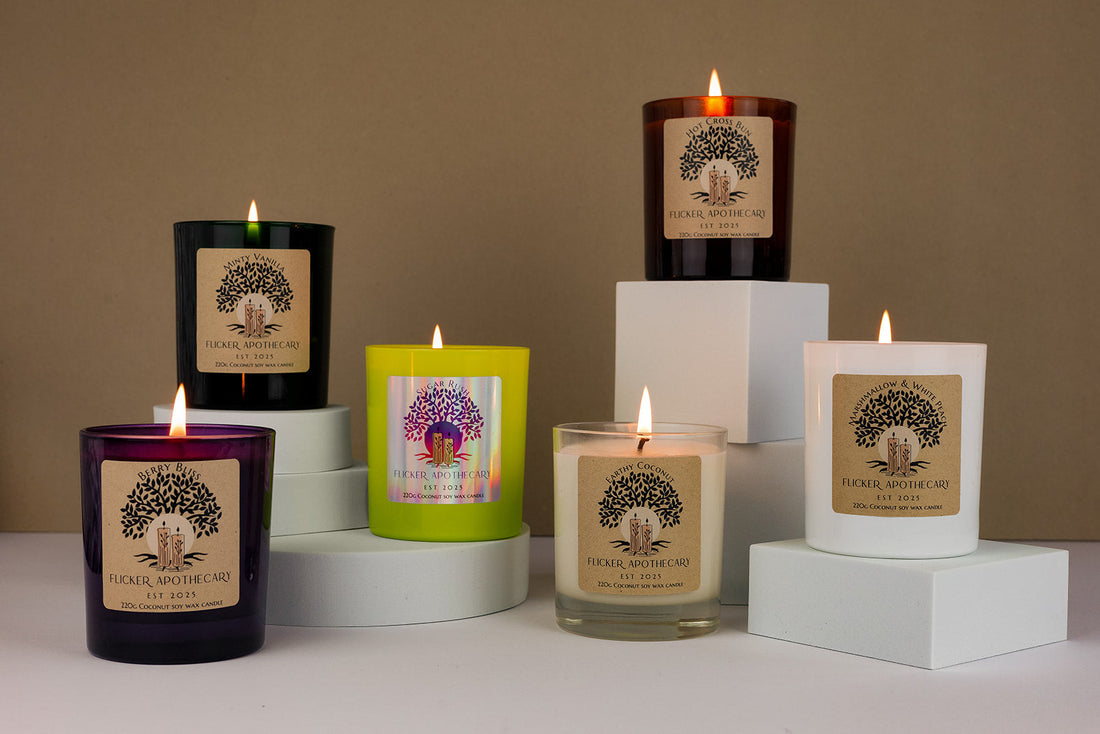 Picture of six candles on various platforms, lit with a warm glow in various different scents and glass coloured jars